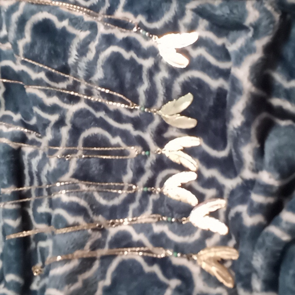 6 sliver tone feather necklaces never been worn brand new